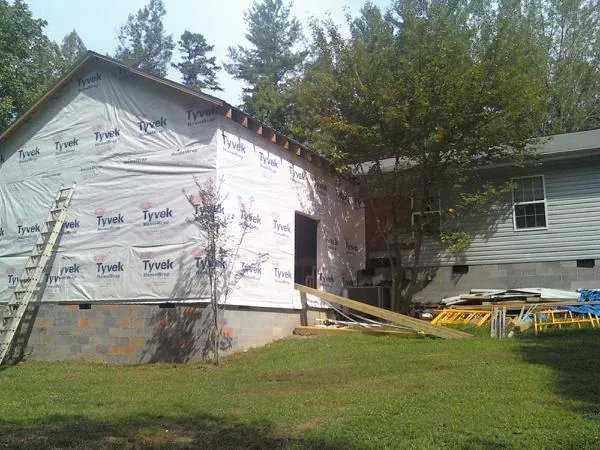 Tyvek wrapped gable on a new room addition beside an existing home in Rush Springs